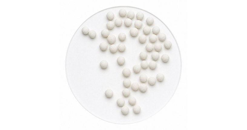 Calcium sulfite balls on a white ground